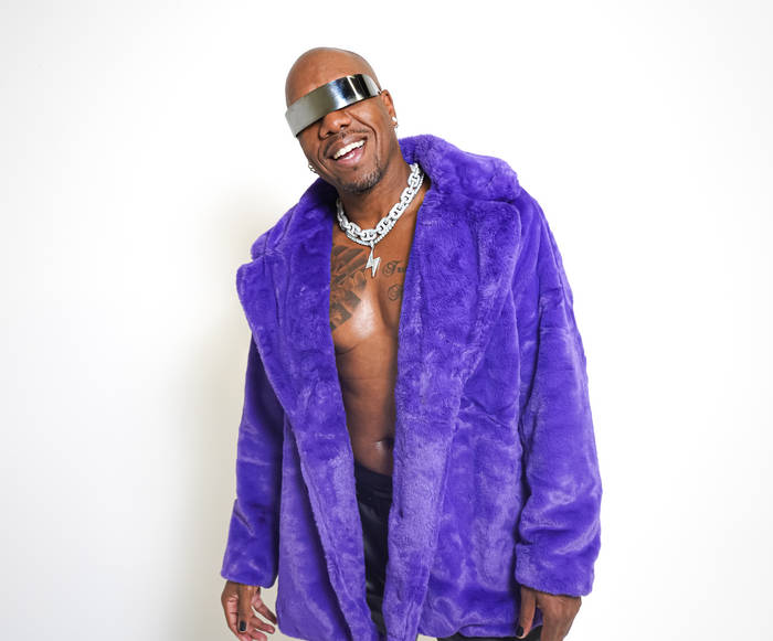 DJ 4korners in a purple mink fur jacket